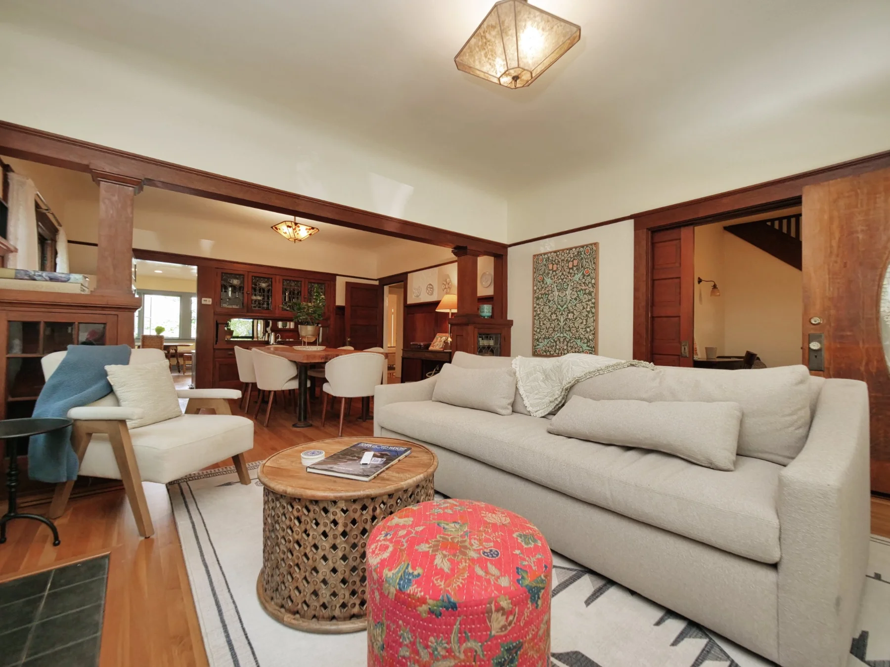 Main Floor living room with original woodwork and dining room beyond